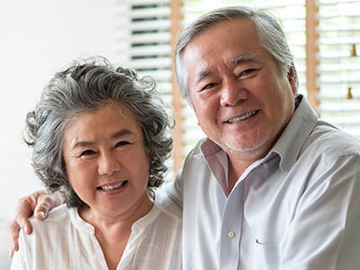 Elderly couple smiling together in a cozy setting