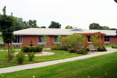 Exterior view of the nursing facility with garden and path