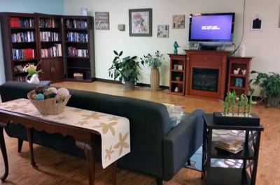 Cozy common area with seating and bookshelves