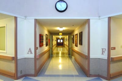 Long hallway with clock and artwork on walls
