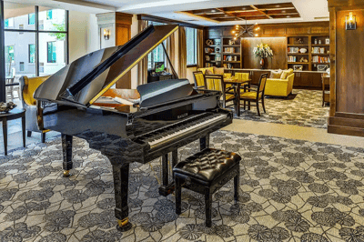 Interior common area with a grand piano and seating