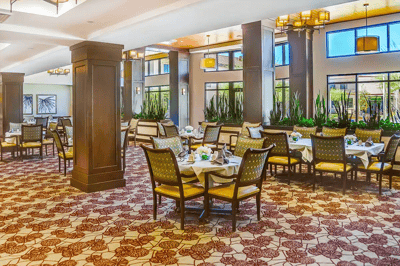 Bright and elegant dining room with tables set for meals