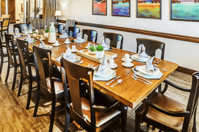 Dining area set up for a meal with decorative table settings