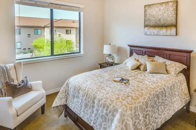 Cozy private resident room with a bed and chair