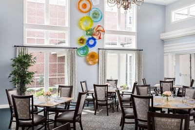 Bright dining room with decorative wall art and tables set for meals