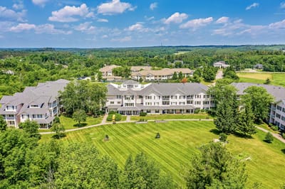 Aerial view of a senior living facility with landscaped grounds