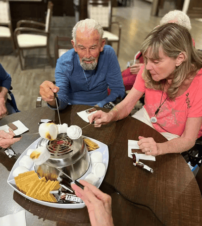Residents enjoying a s'mores activity in a common area