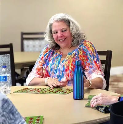 Resident enjoying a bingo game in an activity room