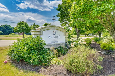 Exterior sign for Solstice Senior Living at Bangor surrounded by greenery