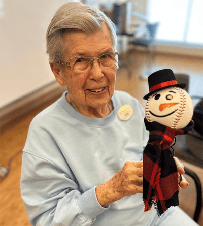 Resident enjoying a craft project with a snowman figure