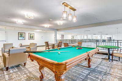 Bright common area with a pool table and seating