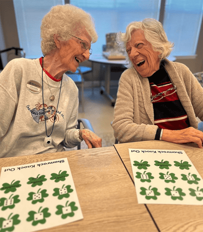 Two residents laughing during an activity.