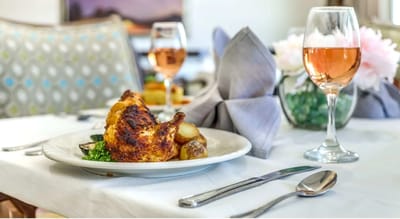 A beautifully plated meal with wine on a dining table