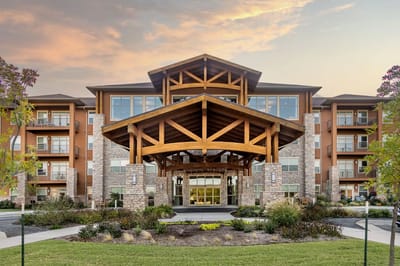 Exterior view of Legacy Retirement Residence building at sunset