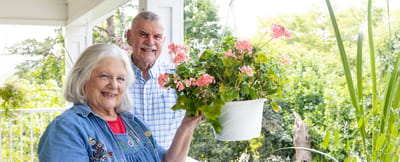 Residents enjoying gardening on a sunny porch