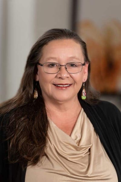 A woman smiling in a professional setting