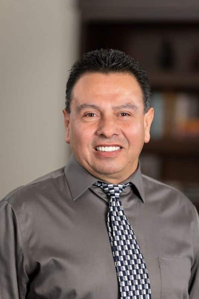 Portrait of a smiling male staff member in a dress shirt