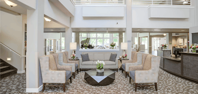 Bright lobby area with seating and floral arrangements