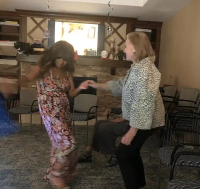 Residents dancing in a cozy activity room