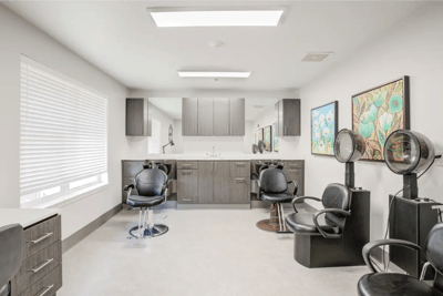 Brightly lit hair salon with styling chairs
