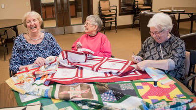 Residents engaged in a quilting activity