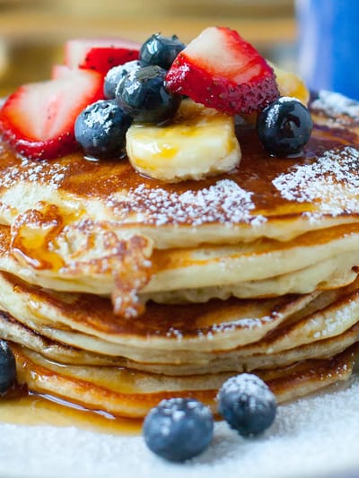 Delicious stack of pancakes topped with fruits
