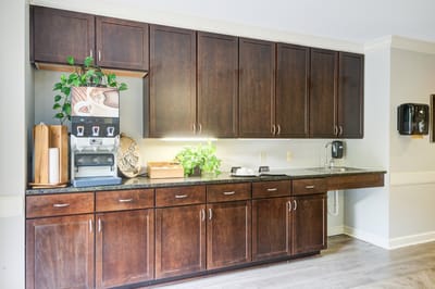 Interior kitchen area with cabinets and coffee machine