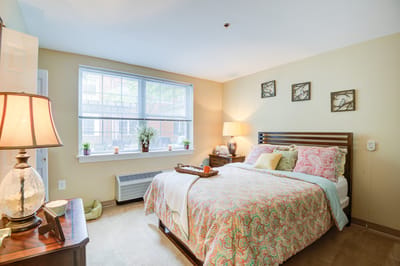 Cozy resident bedroom with natural light and decor