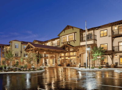 Exterior view of a senior living facility at dusk