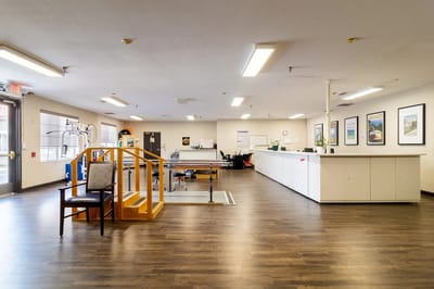 Bright interior of a facility's common area with seating and equipment