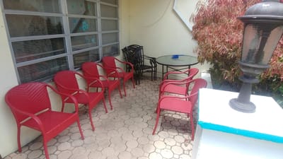 Outdoor seating area with red chairs and a table