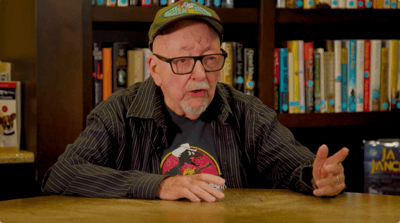 Elderly man discussing in a cozy library space