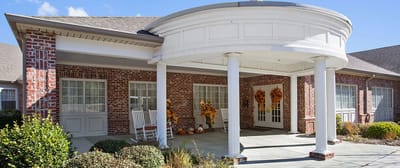 Exterior view of assisted living facility entrance decorated for fall