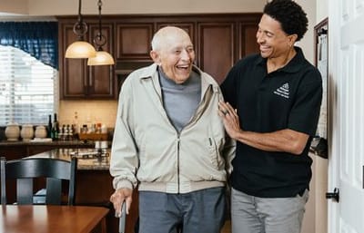 Always Best Care Of Central Ohio, nursing home in Westerville, OH — Older man smiling with caregiver in a cozy kitchen