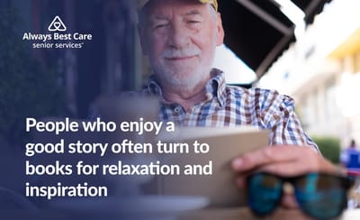 Senior man reading a book in a café setting