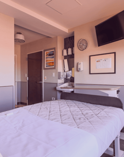 Interior view of a private resident room with a bed and amenities