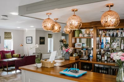 Bright lounge area with decorative lighting and a bar