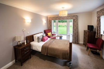 Cozy resident room with a double bed and sitting area