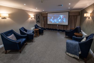 Cozy common area with comfortable seating and a projector