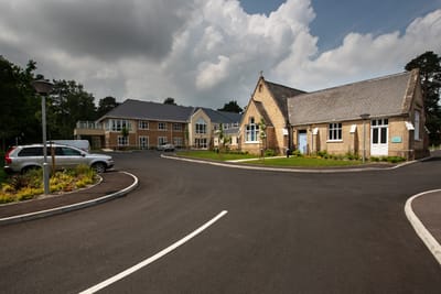 Exterior view of Pine Martin Grange with landscaped surroundings