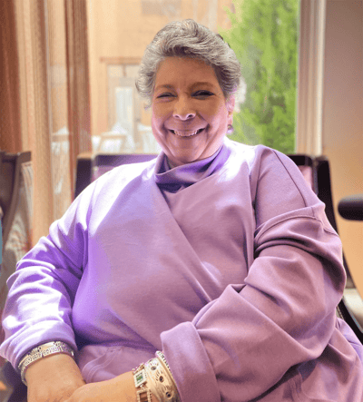 Resident smiling in a brightly lit common area