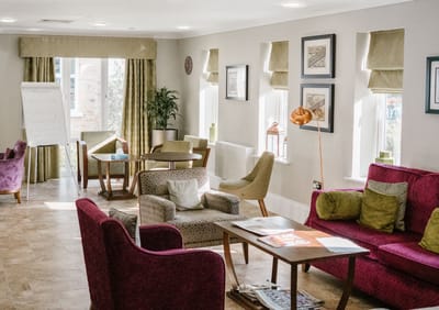 Common area with seating and tables in a bright lounge