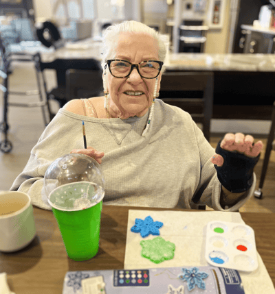 A resident engaged in a painting activity in the common area