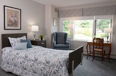 Cozy private resident room with a bed and furnishings