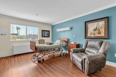 Private resident room with bed and armchair