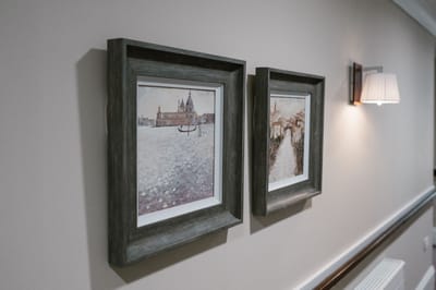Framed artwork in a well-lit hallway