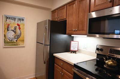 A kitchen area with appliances and decor