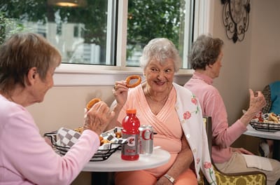 Residents enjoying snacks in a dining area