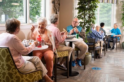 Residents enjoying snacks and conversation in a common area