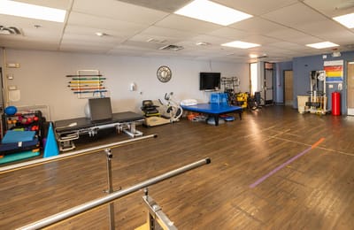 Interior therapy room with exercise equipment and therapy tools
